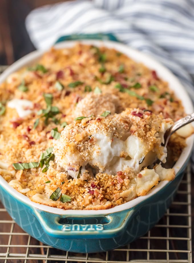 a scoop of Cheesy Bacon Gnocchi Bake in a blue baking dish