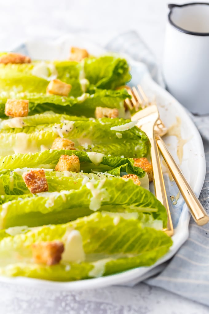 caesar salad with two gold forks