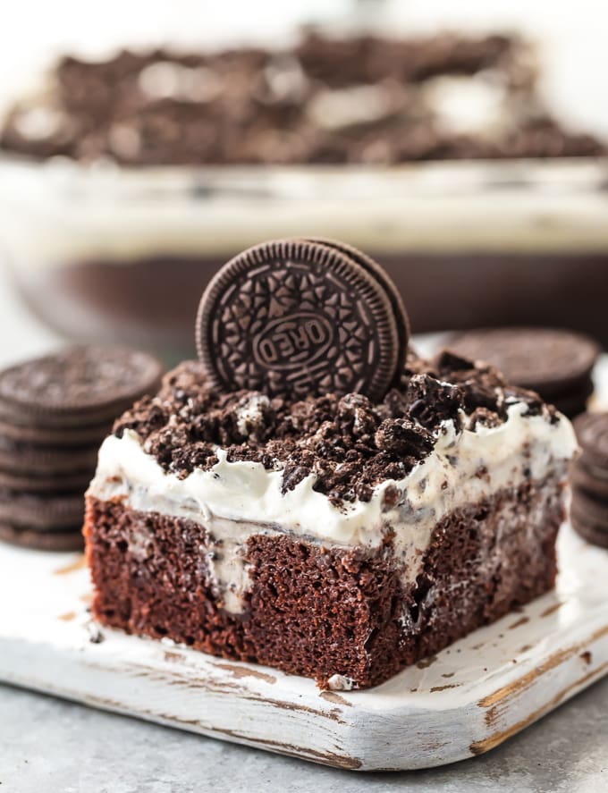 This CREAMY OREO POKE CAKE is one of our favorite EASY and delicious cakes to throw together for any occasion. This moist and flavorful cake is layered with chocolate cake, oreo pudding, cool whip, and crushed oreos! Perfect for birthday parties, holiday get togethers, or for celebrating making it to Friday. So good!