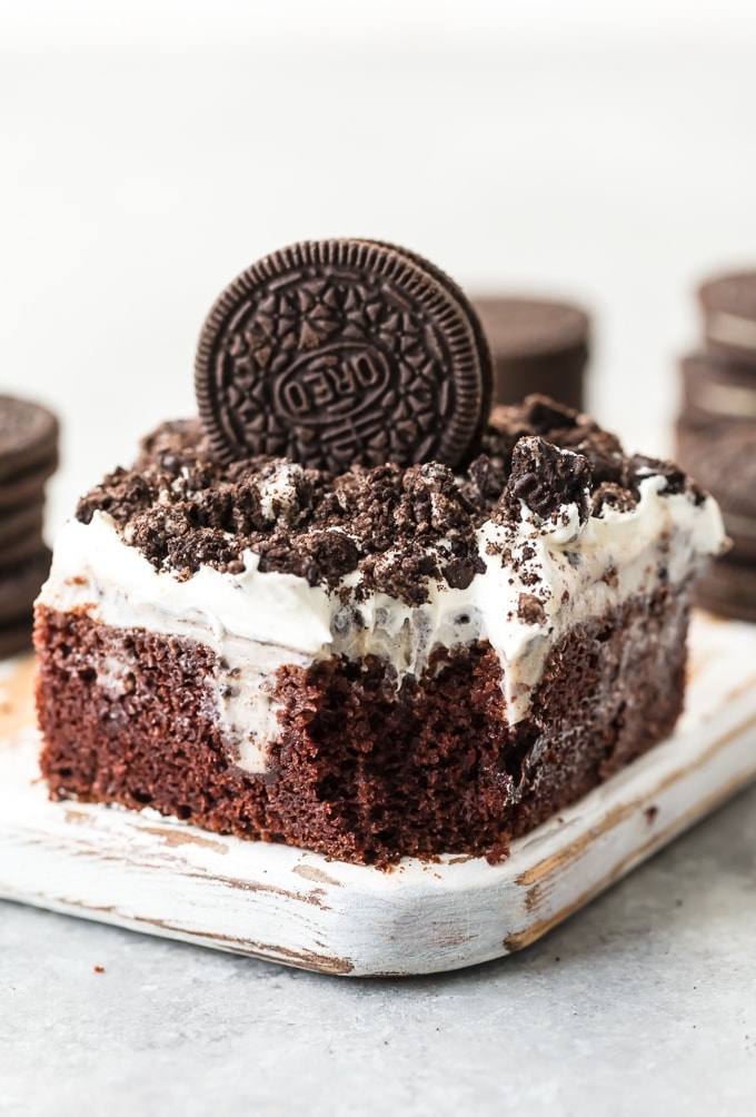 This CREAMY OREO POKE CAKE RECIPE is one of our favorite EASY and delicious cakes to throw together for any occasion. This moist and flavorful cookies and cream cake is layered with chocolate cake, Oreo pudding, cool whip, and crushed Oreos! It's the perfect OREO CAKE RECIPE for birthday parties, holiday get togethers, or for celebrating making it to Friday. So good!