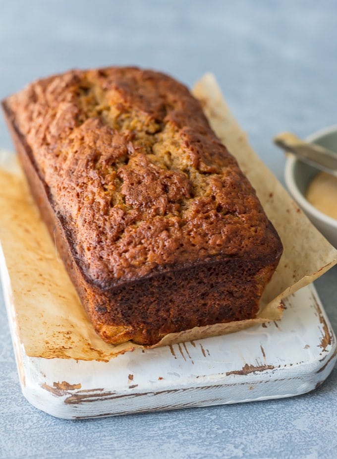 A loaf of banana bread on cutting board