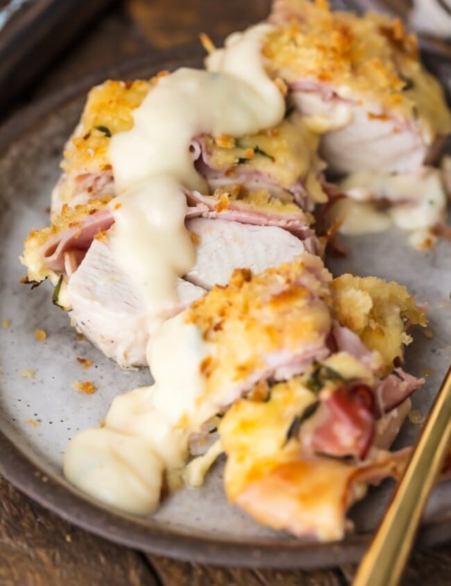 Easy Chicken Cordon Bleu with the BEST Chicken Cordon Bleu Sauce EVER is my favorite recipe for entertaining a crowd. Instead of spending time rolling and stuffing, this Chicken Cordon Bleu Recipe has layers of chicken, ham, cheese, bread crumbs, and is delicious white wine dijon sauce. Get ready to learn how to make Chicken Cordon Bleu as well as what to SERVE with Chicken Cordon Bleu. Best easy chicken recipe ever.