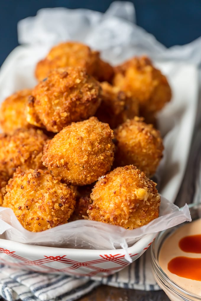 These FRIED BUFFALO CHICKEN DIP BITES are amazing! Balls of cheesy buffalo chicken dip rolled twice in breading and deep fried to pop-able perfection. This is one of our favorite game day recipes for tailgating. Bring on the Super Bowl!