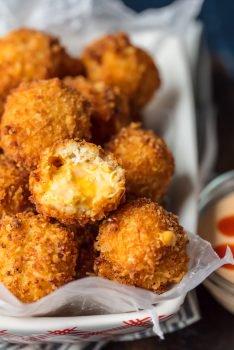 These FRIED BUFFALO CHICKEN DIP BITES are amazing! Balls of cheesy buffalo chicken dip rolled twice in breading and deep fried to pop-able perfection. This is one of our favorite game day recipes for tailgating. Bring on the Super Bowl!