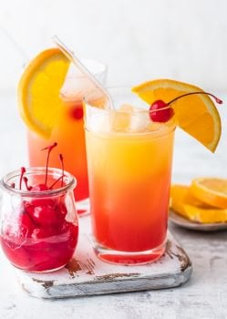 This GAME DAY TEQUILA SUNRISE is tailor made for tailgating! Made with Orange Juice, Grenadine, Tequila, and Beer, this fun cocktail is loved by all and an awesome way to start the day cheering for your favorite team. The ultimate brunch cocktail!