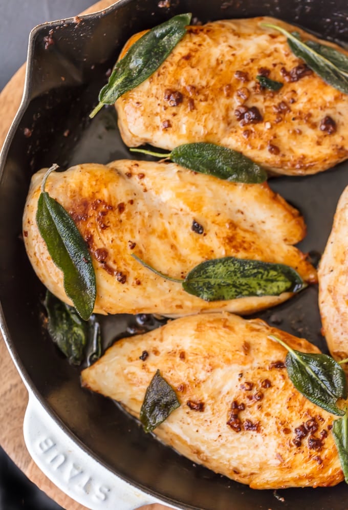 Garlic Chicken Breast topped with crispy sage in frying pan