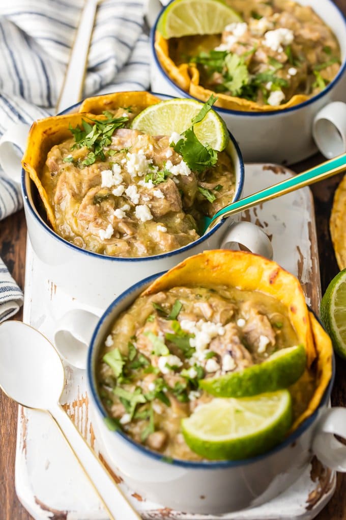 bowls of chili verde with spoons