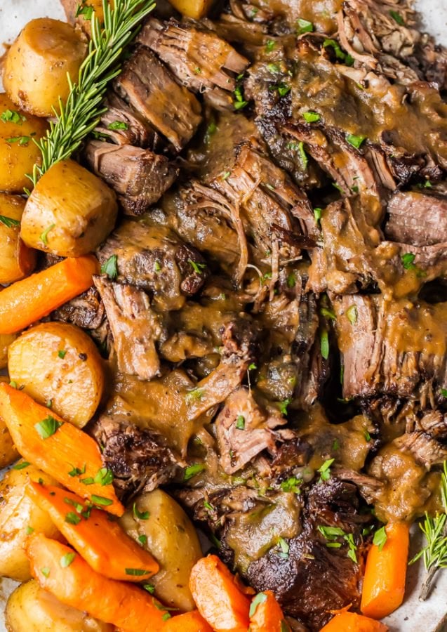 close up on pressure cooker pot roast with carrots and potatoes covered in gravy