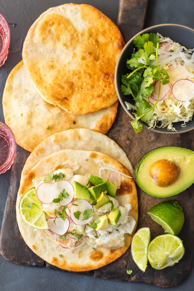 This Margarita Fish Tacos Recipe is so fresh and delicious. The flavors in these FISH TACOS are off the hook! Citrus from limes and oranges, tequila, and more brighten the fish flavors and when mixed with the acidic slaw these just cannot be beat. Cod Fish Tacos are the ultimate light recipe to start off the new year. Healthy can be just as delicious as this creative Tex-Mex recipe proves.