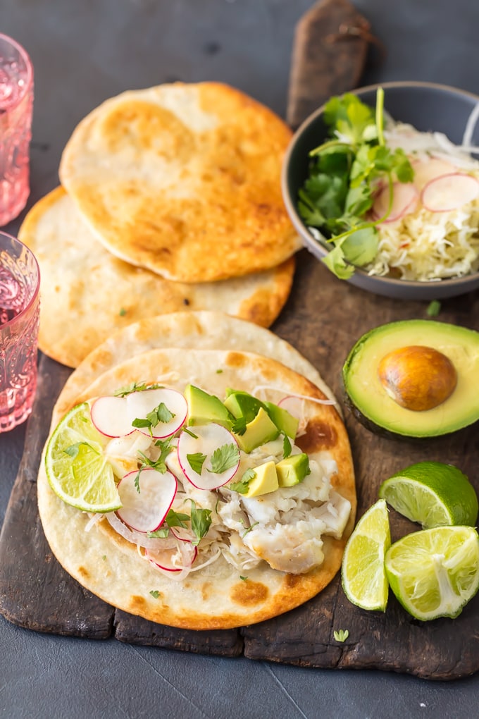 Cod fish tacos with fresh lime, avocado, and tortillas