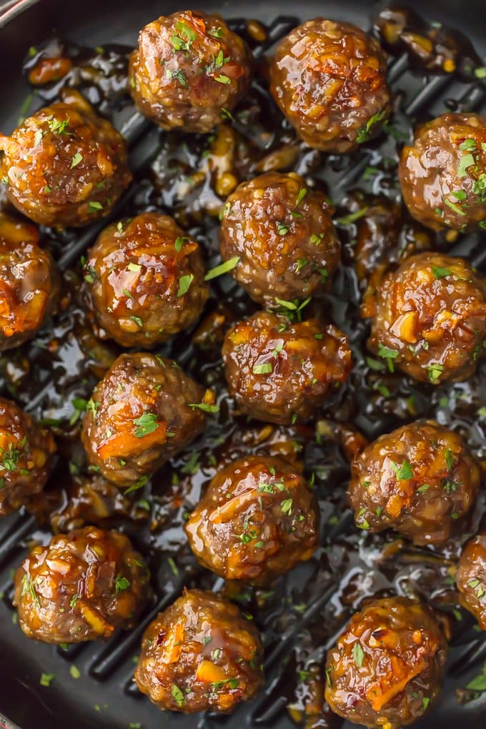 Meatballs arranged on a pan, covered in orange marmalade sauce