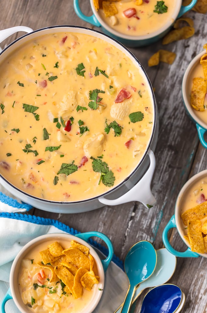 Cheesy Chicken Chowder in large serving pot with small bowls of chowder surrounding it