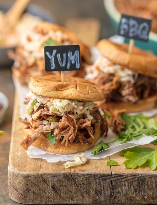 Crockpot BBQ Pork Sandwiches are a must make recipe for any busy family. These SLOW COOKER BBQ PORK SANDWICHES are the ultimate fun finger food for any party! Use the meat for sliders, stuff them into quesadillas, or eat it over rice. The possibilities are endless!