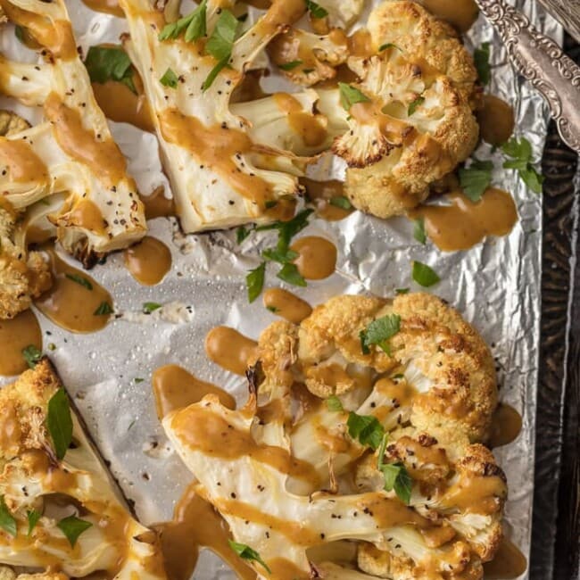 This CAULIFLOWER STEAK RECIPE is a flavorful vegetarian alternative. These THAI PEANUT ROASTED CAULIFLOWER STEAKS are just the right amount of creamy, spicy, and tasty. This easy vegetarian meal or side is always a hit. SO MUCH FLAVOR!