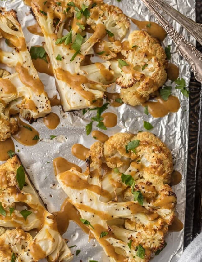This CAULIFLOWER STEAK RECIPE is a flavorful vegetarian alternative. These THAI PEANUT ROASTED CAULIFLOWER STEAKS are just the right amount of creamy, spicy, and tasty. This easy vegetarian meal or side is always a hit. SO MUCH FLAVOR!