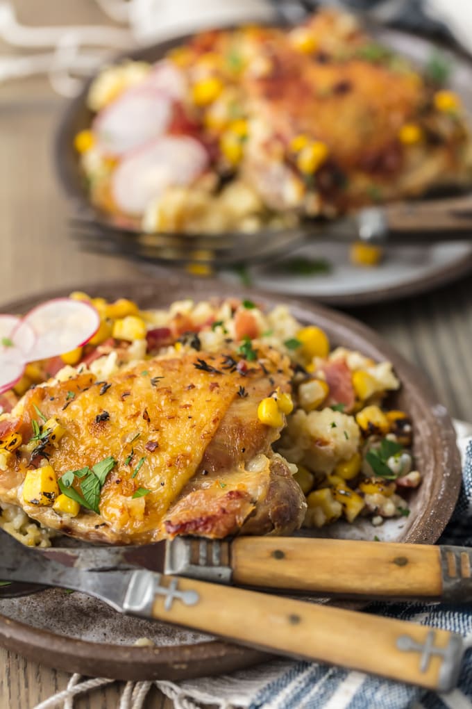 Plate of chicken and couscous with bacon and corn