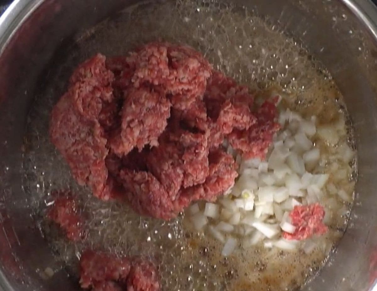 Cooking ground beef and onions in the Instant Pot.