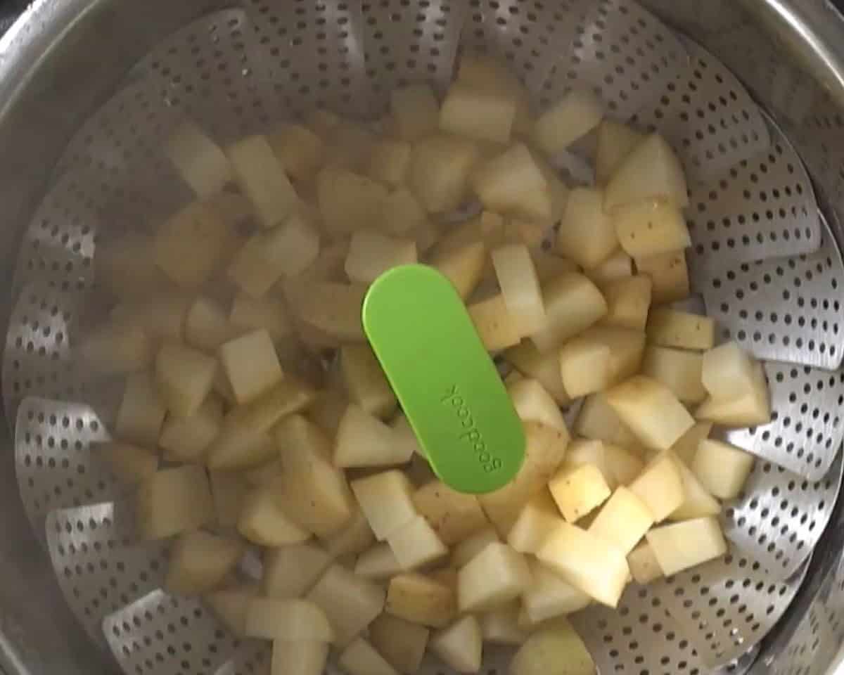 Cubed potatoes in a steamer in the Instant Pot.