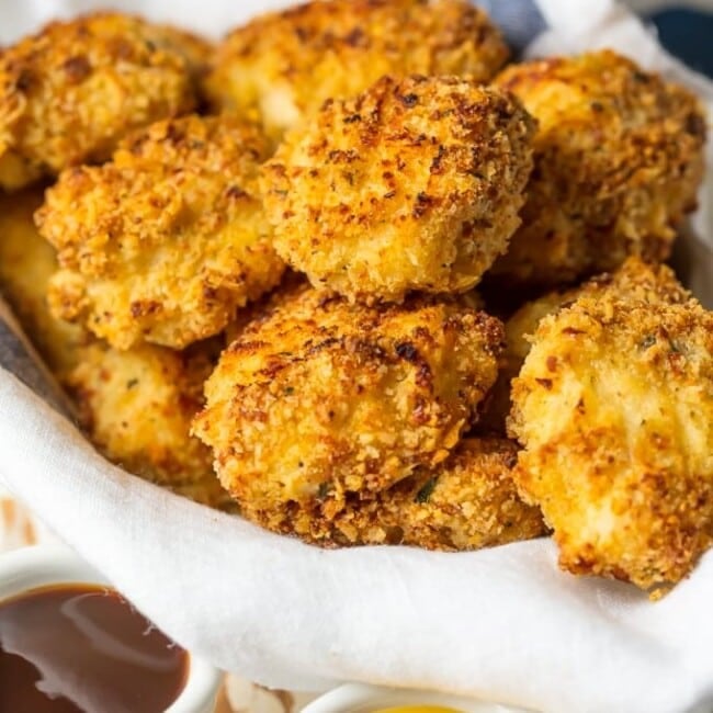 Baked Chicken Nuggets are a must make for any busy family. These BAKED EXTRA CRISPY PARMESAN CHICKEN NUGGETS will blow your mind and become an instant family favorite. Made healthier by baking instead of frying, you'll never miss the grease. Kids and adults will be requesting these flavorful Homemade Chicken Nuggets again and again!