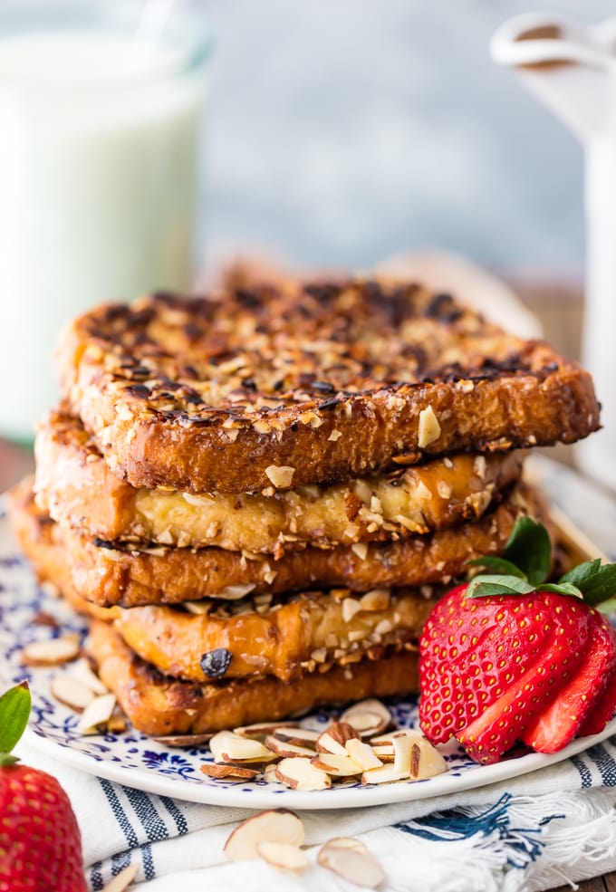 Almond crusted french toast on a plate with strawberries and almonds 