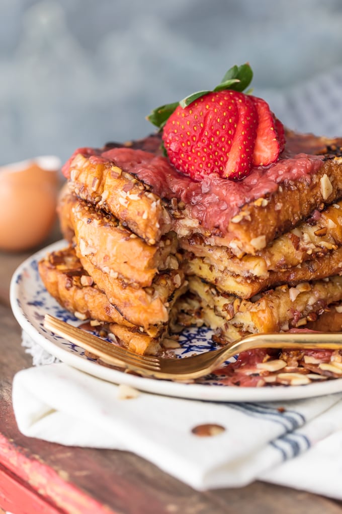 A stack of french toast with a bite taken out of it