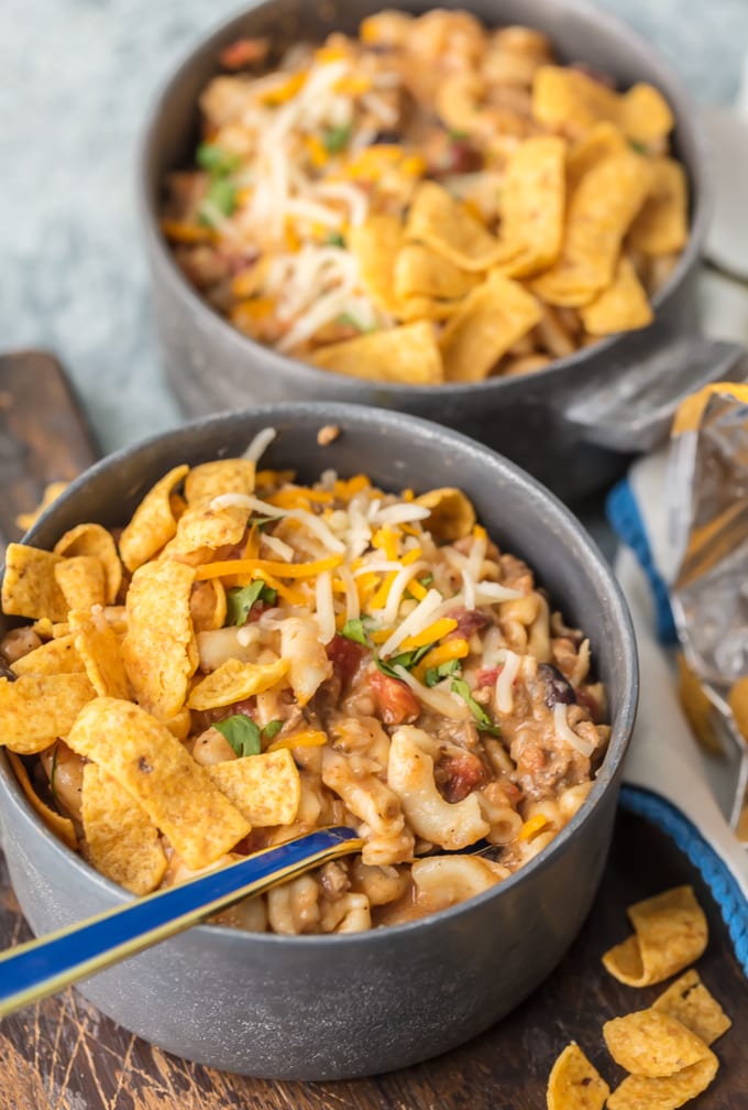 chili mac in bowls topped with fritos and cheese