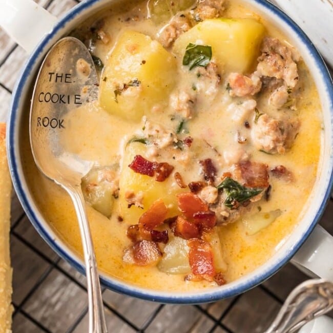 Instant Pot Zuppa Toscana is my new go-to Instant Pot Recipe! Every time we go to Olive Garden I get Zuppa Toscana and I just love that I can make this DELICIOUS copycat recipe at home in under 30 minutes! We first fell in love with this hearty and creamy soup at Olive Garden but I love this quick pressure cooker version even more. This Zuppa Toscana Recipe is loaded with sausage, bacon, potatoes, spinach, and so much flavor.