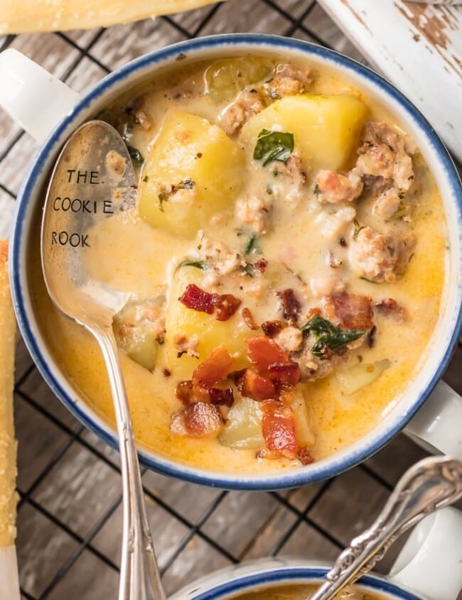 Instant Pot Zuppa Toscana is my new go-to Instant Pot Recipe! Every time we go to Olive Garden I get Zuppa Toscana and I just love that I can make this DELICIOUS copycat recipe at home in under 30 minutes! We first fell in love with this hearty and creamy soup at Olive Garden but I love this quick pressure cooker version even more. This Zuppa Toscana Recipe is loaded with sausage, bacon, potatoes, spinach, and so much flavor.