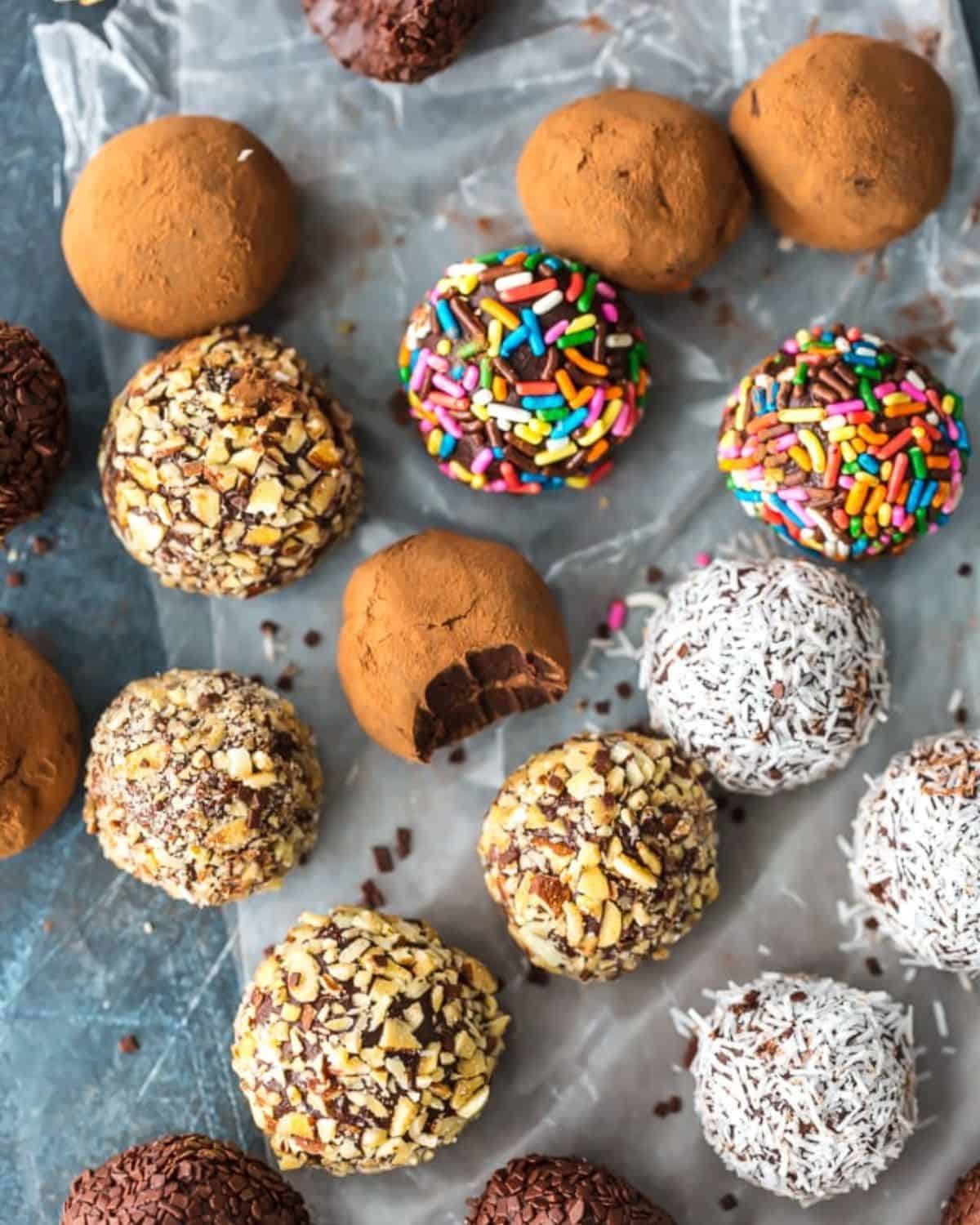 Chocolate Truffles are a must make recipe for any chocolate lover. This Easy Chocolate Truffle Recipe is made with only 5 ingredients and has a unique and amazing flavor. If you've wondered how to make chocolate truffles, this recipe is for you. Softer than fudge, bite-sized, and utterly perfect; this is a chocolate dessert recipe you simply can't miss. Chocolate truffles rolled in coconut, nuts, sprinkles, and cocoa powder.