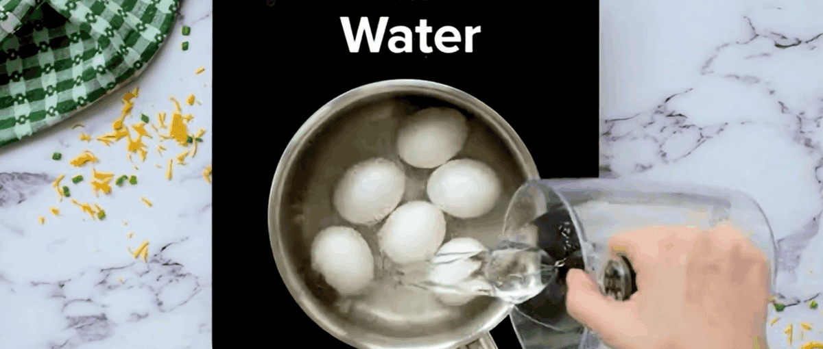 Eggs in a pot being covered by water.