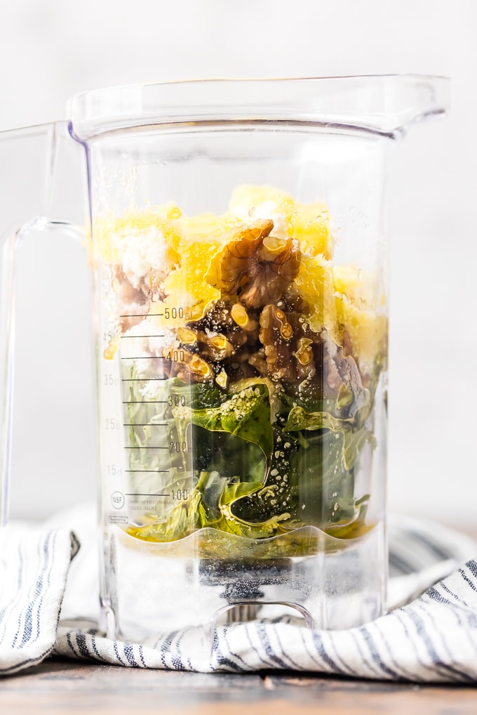 Walnuts, basil, garlic, and olive oil in a blender