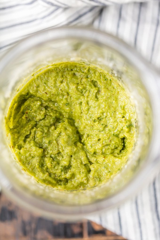 Bright green basil pesto in a blender