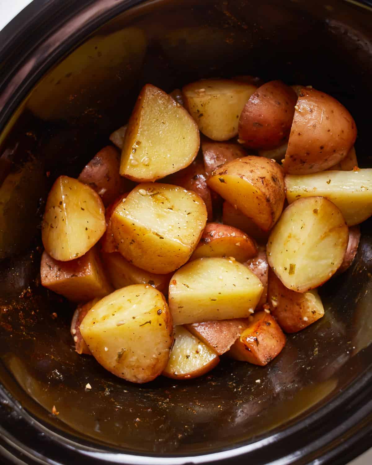 A crockpot filled with potatoes.