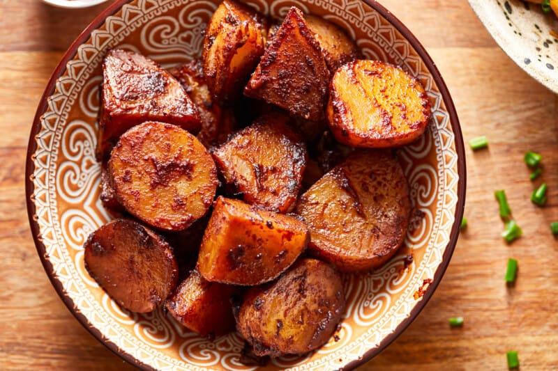 Roasted slow cooker potatoes on a wooden table.