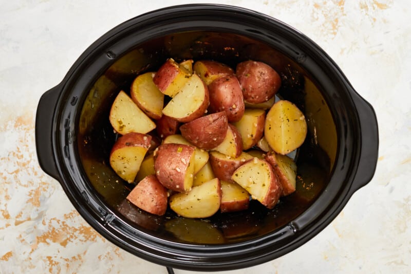 A crockpot filled with potatoes, slow-cooked to perfection.