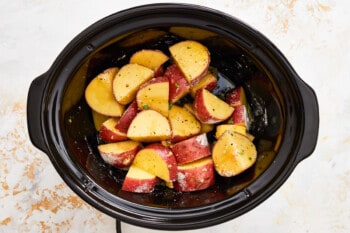 Crockpot potatoes cooking on a white background.