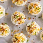 DEVILED EGG RECIPE LOADED just like a Loaded Baked Potato! Smothered in a mixture of cheese, bacon, sour cream, chives, and more! This is the BEST Deviled Eggs Recipe perfect for Easter, Christmas, or any day in between. The ultimate holiday Easy Deviled Eggs.