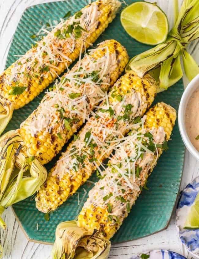 mexican grilled corn on a green platter