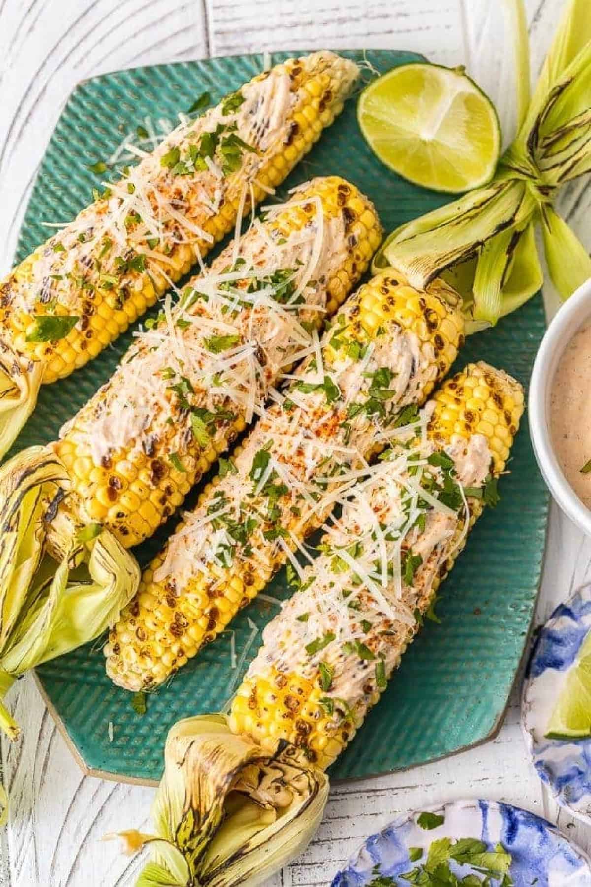 mexican grilled corn on a green platter