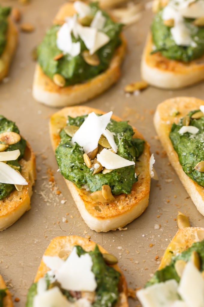This Parmesan Spinach Dip Crostini is such a classy and unique appetizer to serve at your next party. Spinach Dip is loved by all, and now you don't need the chips to enjoy! Warm Parmesan Spinach Dip piled onto toasty French Bread is the ultimate in bruschetta recipes. This is one of our favorite game day or holiday recipes to make in a pinch.