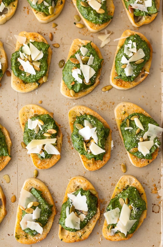 This Parmesan Spinach Dip Crostini is such a classy and unique appetizer to serve at your next party. Spinach Dip is loved by all, and now you don't need the chips to enjoy! Warm Parmesan Spinach Dip piled onto toasty French Bread is the ultimate in bruschetta recipes. This is one of our favorite game day or holiday recipes to make in a pinch.