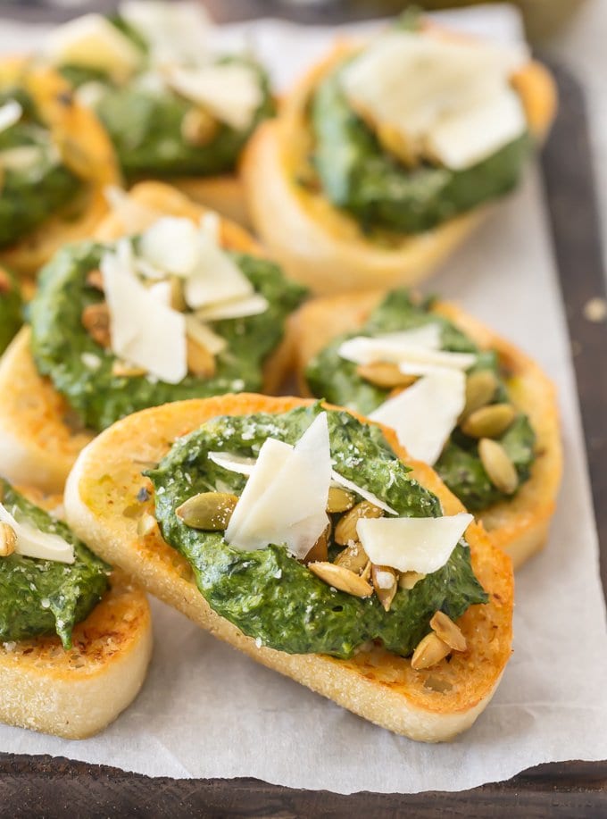This Parmesan Spinach Dip Crostini is such a classy and unique appetizer to serve at your next party. Spinach Dip is loved by all, and now you don't need the chips to enjoy! Warm Parmesan Spinach Dip piled onto toasty French Bread is the ultimate in bruschetta recipes. This is one of our favorite game day or holiday recipes to make in a pinch.