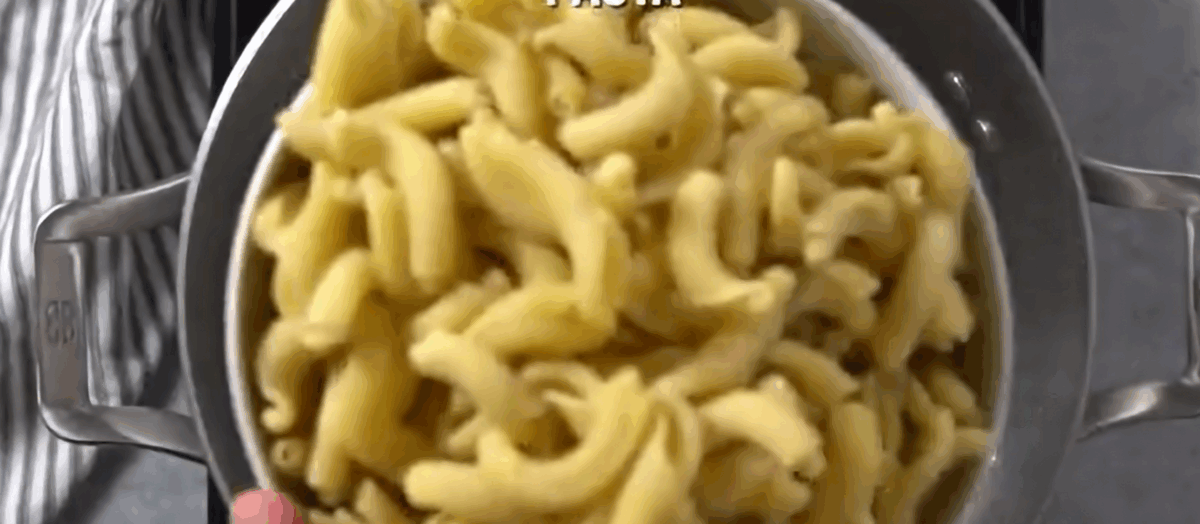 Pasta in a bowl ready to be poured into a pot of boiling water.