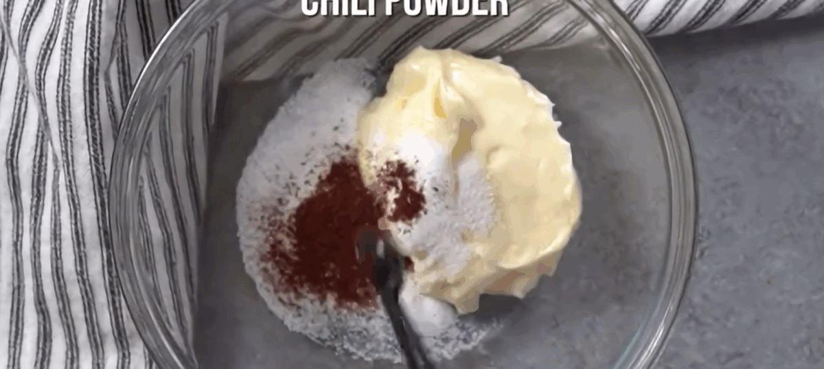 Making the dressing in a glass bowl.