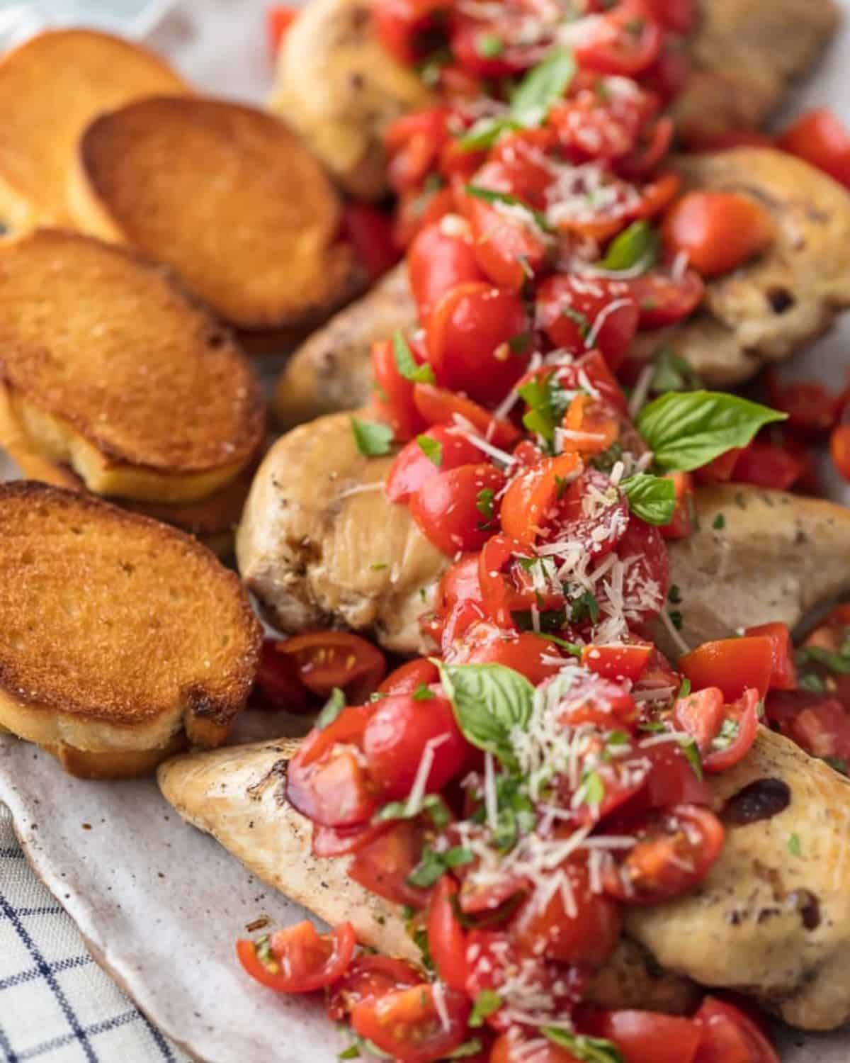 Bruschetta Chicken with tomatoes, basil, balsamic, and parmesan cheese has always been one of my favorite recipes, and now it's even easier to make! This Instant Pot Chicken Bruschetta recipe is a fresh, light, quick, and EASY Instant Pot Chicken Recipe! Instant Pot Bruschetta Chicken is one of our go-to easy weeknight meals. Chicken breasts with bruschetta and toasted baguette.