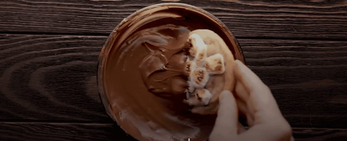 Dipping the cookies in melted chocolate. 