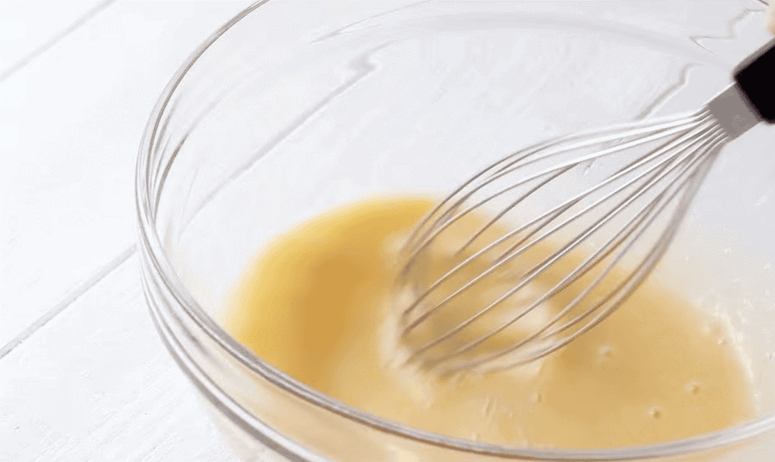 Whisking eggs in a glass bowl.