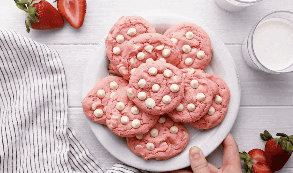 Strawberry cookies with white chocolate chips on a plate. 