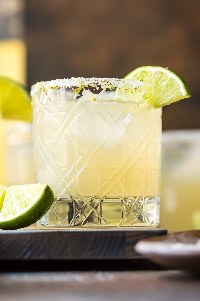 Short glass of a Classic Margarita with lime wedges