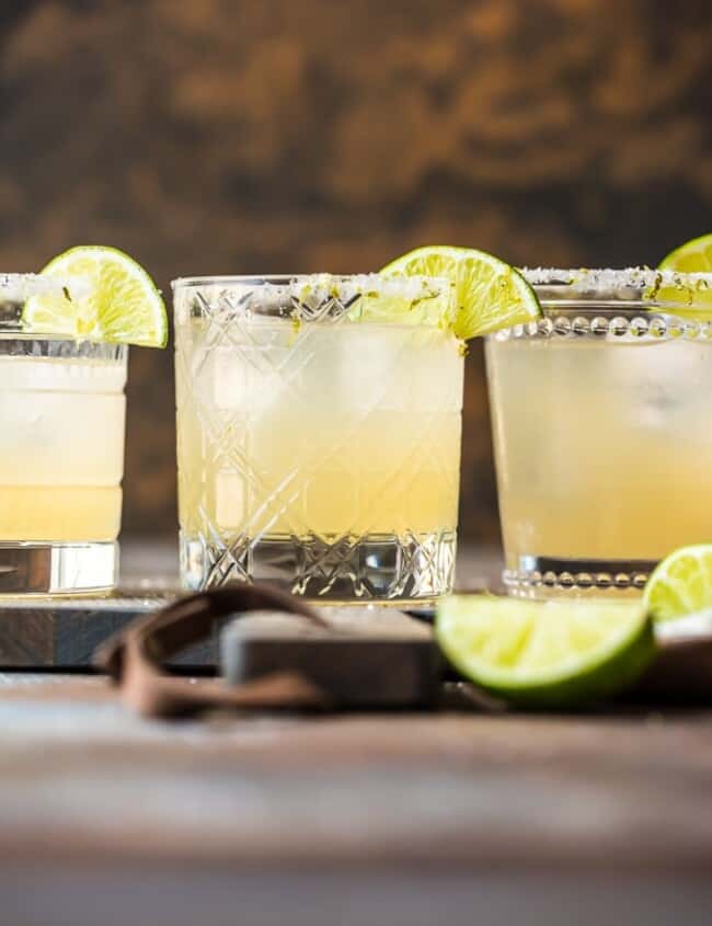 margaritas in glasses with lime garnish